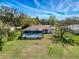 Aerial view of backyard with large pool, screened enclosure, and fenced yard at 8367 Apple Orchard Rd, Spring Hill, FL 34608