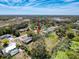 An aerial view shows the home in a residential neighborhood with a pond at 8367 Apple Orchard Rd, Spring Hill, FL 34608