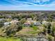 Aerial view of home with screened in pool and a pond at 8367 Apple Orchard Rd, Spring Hill, FL 34608