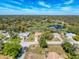 Overhead shot of homes in a community near a lake with green landscape all around at 8367 Apple Orchard Rd, Spring Hill, FL 34608