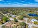 An aerial view shows the home in a residential neighborhood with a pond at 8367 Apple Orchard Rd, Spring Hill, FL 34608