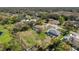 Scenic aerial view showcases a house with a pool and lush green lawn at 8367 Apple Orchard Rd, Spring Hill, FL 34608