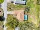 Aerial view of the home's roof and screened in pool, including the driveway at 8367 Apple Orchard Rd, Spring Hill, FL 34608