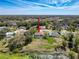 A beautiful aerial view of a home with a pool and large yard near a pond at 8367 Apple Orchard Rd, Spring Hill, FL 34608