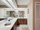 Bright bathroom featuring double sink vanity with marble countertop and a large mirror at 8367 Apple Orchard Rd, Spring Hill, FL 34608
