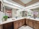 Bathroom with double sinks, vanity, and large mirror at 8367 Apple Orchard Rd, Spring Hill, FL 34608