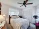 Traditional bedroom with floral bedding, wood furnishings, and a ceiling fan at 8367 Apple Orchard Rd, Spring Hill, FL 34608