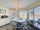 Sunny dining area with wood floors and large windows looking out to the backyard, including a microwave at 8367 Apple Orchard Rd, Spring Hill, FL 34608