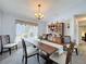 Dining room showcasing a wooden table with seating, chandelier, and window at 8367 Apple Orchard Rd, Spring Hill, FL 34608