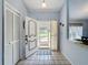 Inviting foyer with tile flooring and decorated front door with view to the outside at 8367 Apple Orchard Rd, Spring Hill, FL 34608