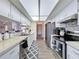 Functional kitchen with white cabinetry, stainless appliances, and tiled backsplash at 8367 Apple Orchard Rd, Spring Hill, FL 34608