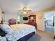 Bedroom featuring a dresser, ceiling fan, neutral walls, and doorway to the bathroom at 8367 Apple Orchard Rd, Spring Hill, FL 34608