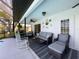 Relaxing screened-in patio with comfortable seating and a ceiling fan at 8367 Apple Orchard Rd, Spring Hill, FL 34608