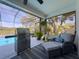 Inviting covered patio with barbecue, seating, and beautiful outdoor views at 8367 Apple Orchard Rd, Spring Hill, FL 34608