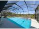 Backyard pool with screened enclosure and scenic views of backyard at 8367 Apple Orchard Rd, Spring Hill, FL 34608