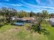 Aerial view of home with screened in pool and a large yard at 8367 Apple Orchard Rd, Spring Hill, FL 34608