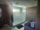 Modern bathroom features a glass-enclosed shower with white marble walls, sleek vanity and a large window at 8501 Hunting Saddle Dr, Hudson, FL 34667