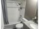 Well-maintained bathroom featuring a shower-tub combo, a modern vanity, and neutral-toned tiling at 8501 Hunting Saddle Dr, Hudson, FL 34667