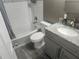 Updated bathroom featuring a shower-tub combo with subway tile and modern vanity at 8501 Hunting Saddle Dr, Hudson, FL 34667
