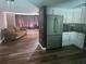 Open floor plan featuring a stainless steel refrigerator, updated kitchen cabinetry and a comfortable living room at 8501 Hunting Saddle Dr, Hudson, FL 34667
