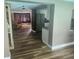 Open floor plan featuring a stainless steel refrigerator, updated kitchen cabinetry and a comfortable living room at 8501 Hunting Saddle Dr, Hudson, FL 34667