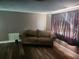 Comfortable living room with hardwood floors and a large window at 8501 Hunting Saddle Dr, Hudson, FL 34667