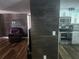 Open-concept living area with wood-look flooring, a modern accent wall, and ample natural light at 8501 Hunting Saddle Dr, Hudson, FL 34667