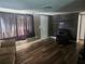 Cozy living room with hardwood floors, neutral walls, and comfortable seating perfect for relaxation at 8501 Hunting Saddle Dr, Hudson, FL 34667