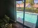 Screened in pool view from a dining table inside at 8501 Hunting Saddle Dr, Hudson, FL 34667