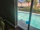 Screened in pool view from inside a dining table at 8501 Hunting Saddle Dr, Hudson, FL 34667