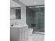 Modern bathroom with white vanity, a glass-enclosed shower, and black and white tiled floors at 9024 Waterbird Way, Brooksville, FL 34613