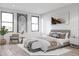 Serene bedroom with a plush bed, stylish artwork, and ample natural light at 9024 Waterbird Way, Brooksville, FL 34613