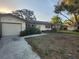 Charming single-story home with a one car garage and a traditional front yard landscape at 10803 Hachita Dr, Port Richey, FL 34668