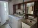 Laundry room featuring a side by side washer and dryer, utility sink, and shelving at 10803 Hachita Dr, Port Richey, FL 34668