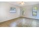 Bedroom with ceramic tile flooring and three windows offering lots of natural light at 11085 Maderia St, Spring Hill, FL 34609