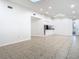 Bright living room with ceramic tile floors, skylight, and an adjacent kitchen area at 11085 Maderia St, Spring Hill, FL 34609