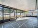 Screened patio featuring a geometric painted floor and views of the fenced backyard at 11085 Maderia St, Spring Hill, FL 34609