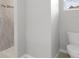 Bathroom featuring neutral walls, wood-style floor, and a tile shower at 11192 Kodiak Wren Rd, Weeki Wachee, FL 34614