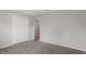 An interior view of a bedroom featuring gray carpet flooring and a double-door closet at 11192 Kodiak Wren Rd, Weeki Wachee, FL 34614
