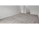 Bedroom with carpet flooring and a view into the hallway at 11192 Kodiak Wren Rd, Weeki Wachee, FL 34614