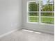 Bright bedroom features tile flooring and a large window at 11192 Kodiak Wren Rd, Weeki Wachee, FL 34614