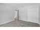 A bright bedroom with plush carpet flooring and a view into a hallway at 11192 Kodiak Wren Rd, Weeki Wachee, FL 34614