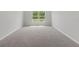 Bedroom with carpet flooring and a large window at 11192 Kodiak Wren Rd, Weeki Wachee, FL 34614
