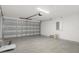 A garage with a sectional garage door and concrete floors at 11192 Kodiak Wren Rd, Weeki Wachee, FL 34614