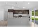 Modern kitchen featuring an island, stainless steel appliances, and contemporary pendant lighting at 11192 Kodiak Wren Rd, Weeki Wachee, FL 34614