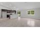 Open-concept kitchen with dark cabinetry, stainless steel appliances, and a large island at 11192 Kodiak Wren Rd, Weeki Wachee, FL 34614