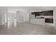 Open concept, the space includes a kitchen with granite countertops and dark cabinetry at 11192 Kodiak Wren Rd, Weeki Wachee, FL 34614