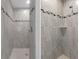 Beautifully tiled shower featuring neutral-colored tile and a handheld shower head at 11192 Kodiak Wren Rd, Weeki Wachee, FL 34614