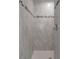 Modern tiled shower featuring a shower head and neutral tile at 11192 Kodiak Wren Rd, Weeki Wachee, FL 34614