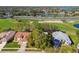 Aerial view showcasing the home's location near a golf course, a lake, and a neighborhood at 11231 Sun Tree Rd, Hudson, FL 34667
